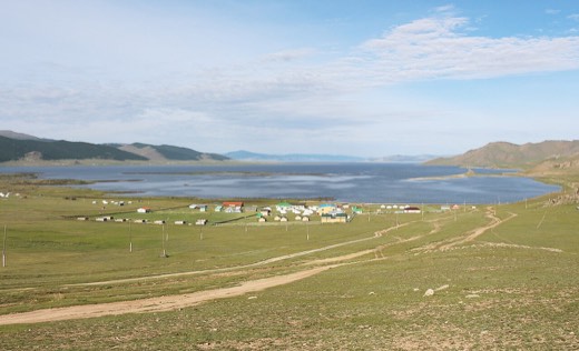 Terkhiin Tsagaan Lake and green steppe with a ger camp in Arkhangai