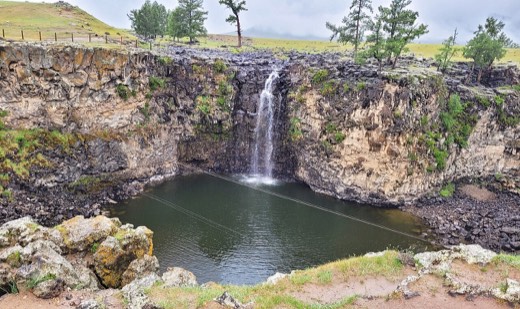 Ulaan Tsutgalan waterfall dropping into a basalt gorge in the Orkhon Valley